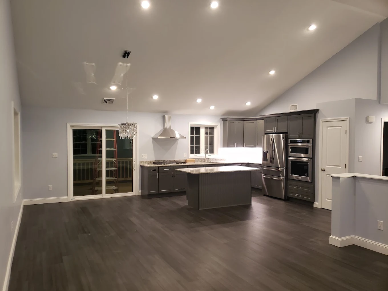 Vaulted ceiling recessed lighting in open kitchen